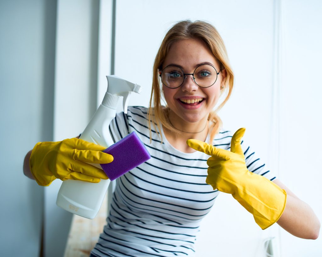 Girl holding cleaning supplies